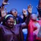 woman raising hands in prayer